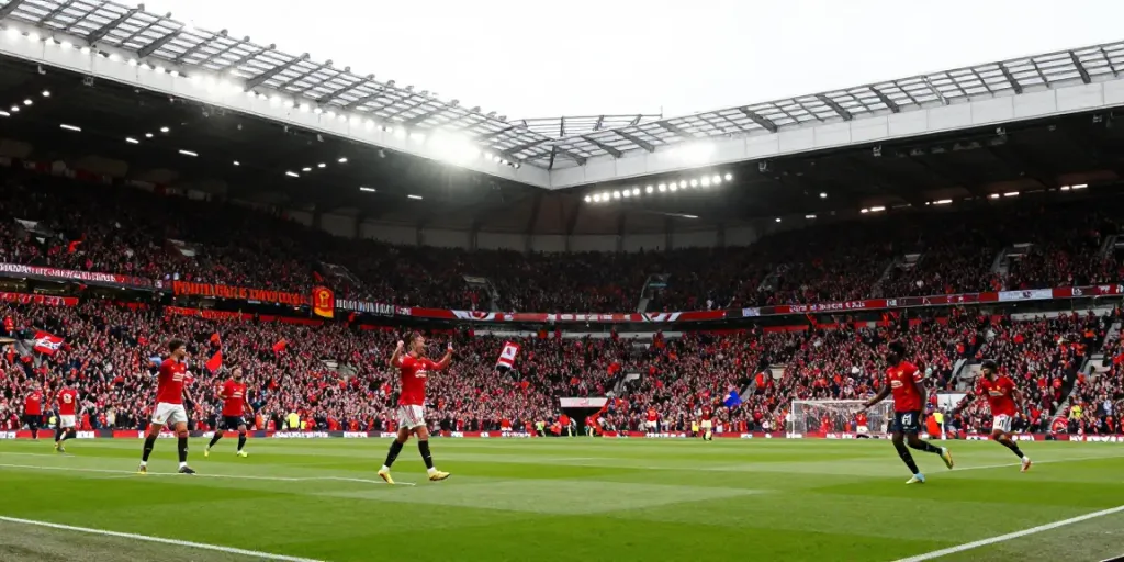 Engaged fans at stadium cheering for แมนยู กับ ลิเวอร์พูล during a thrilling match.